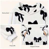 Daisy Dreamer oversized hooded blanket for women featuring a cozy fleece fabric with bows, Highland cow, and candy cane patterns.
